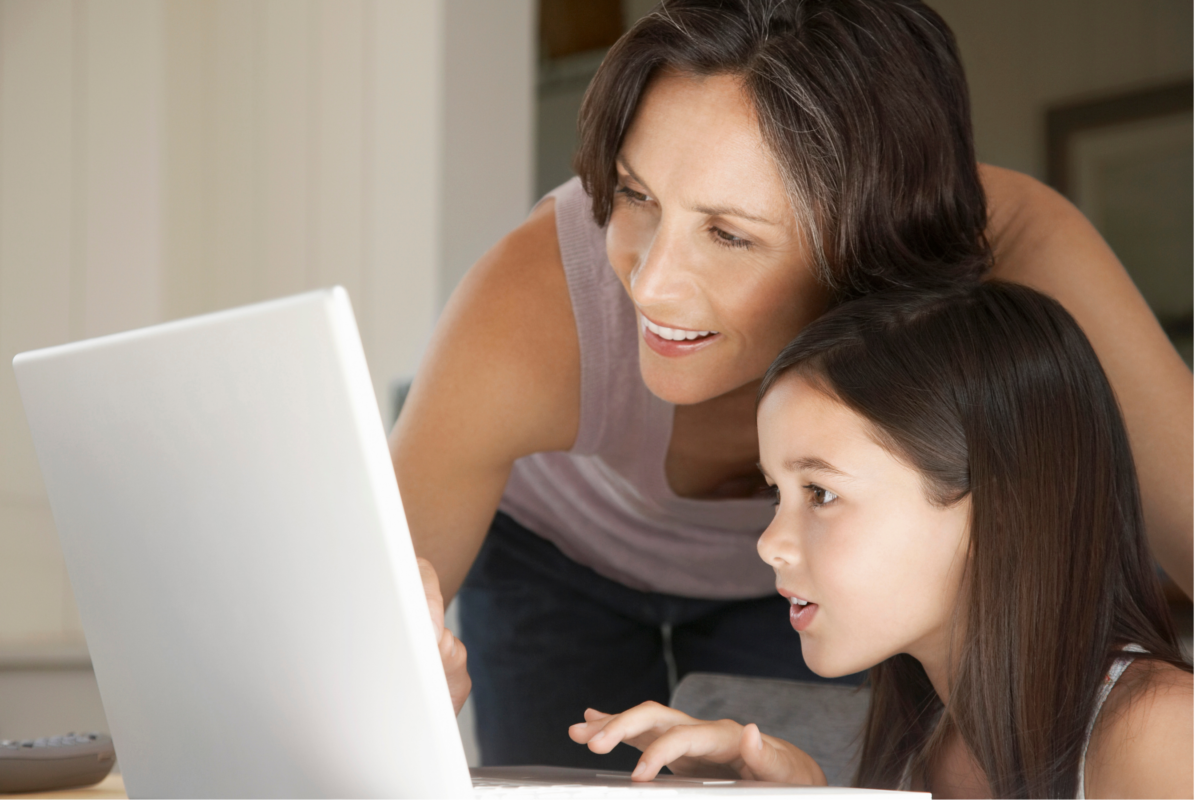 Mom and daughter looking at computer screen